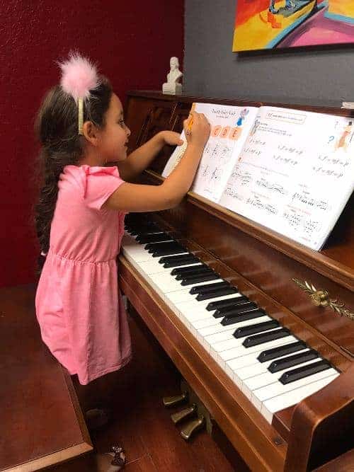 Young piano student working with sheet music
