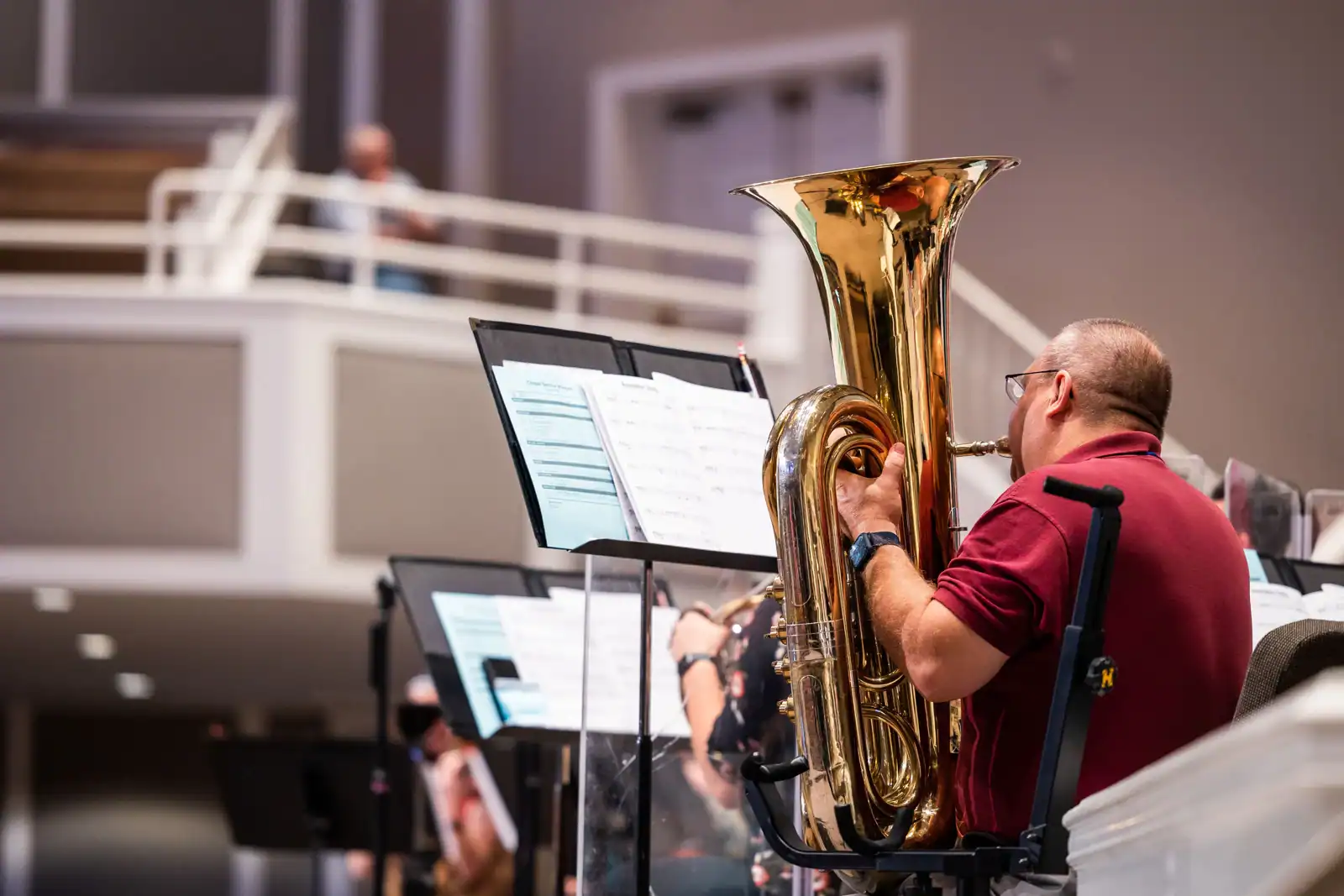 Musician playing tuba in a concert hall